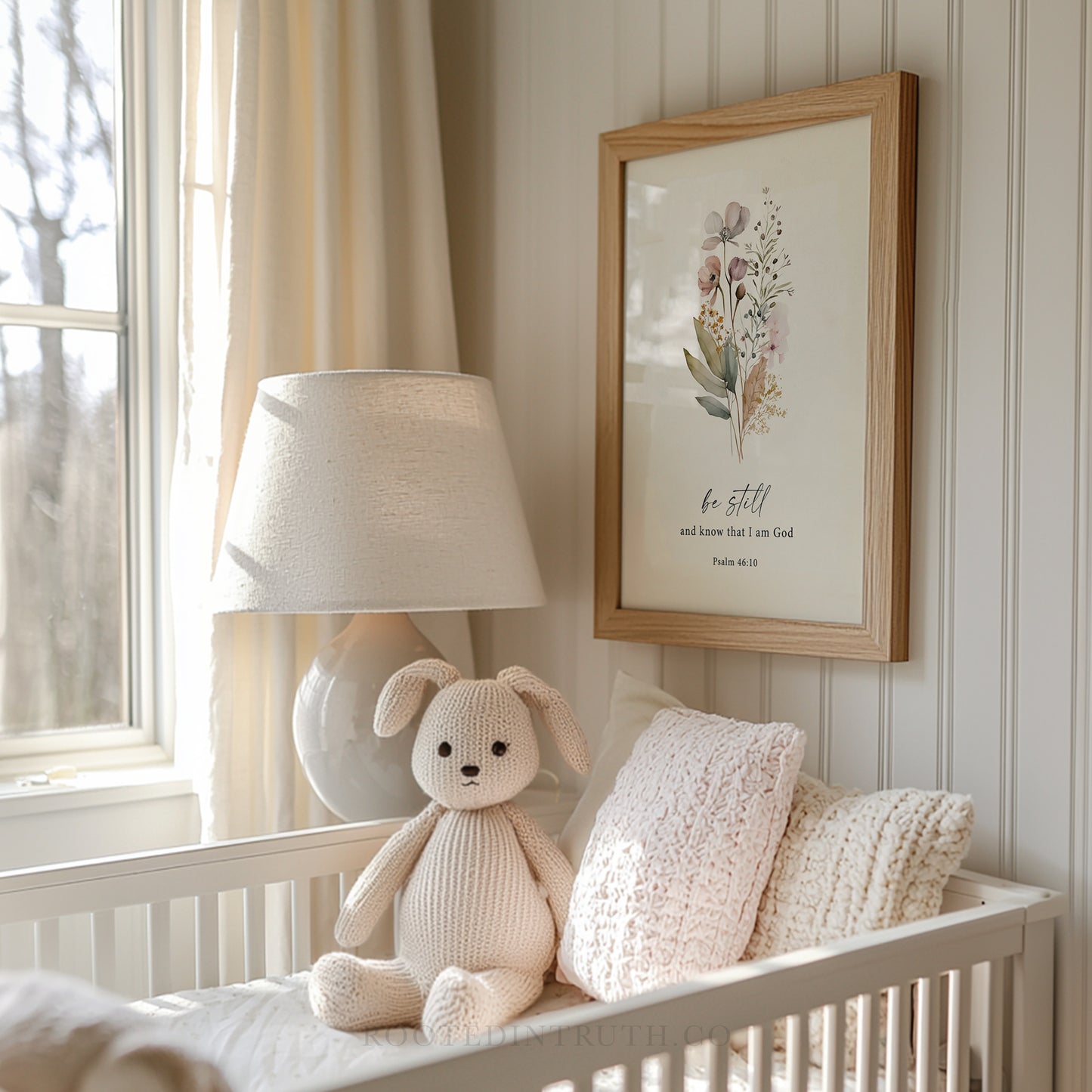 a stuffed animal sitting on a crib next to a lamp