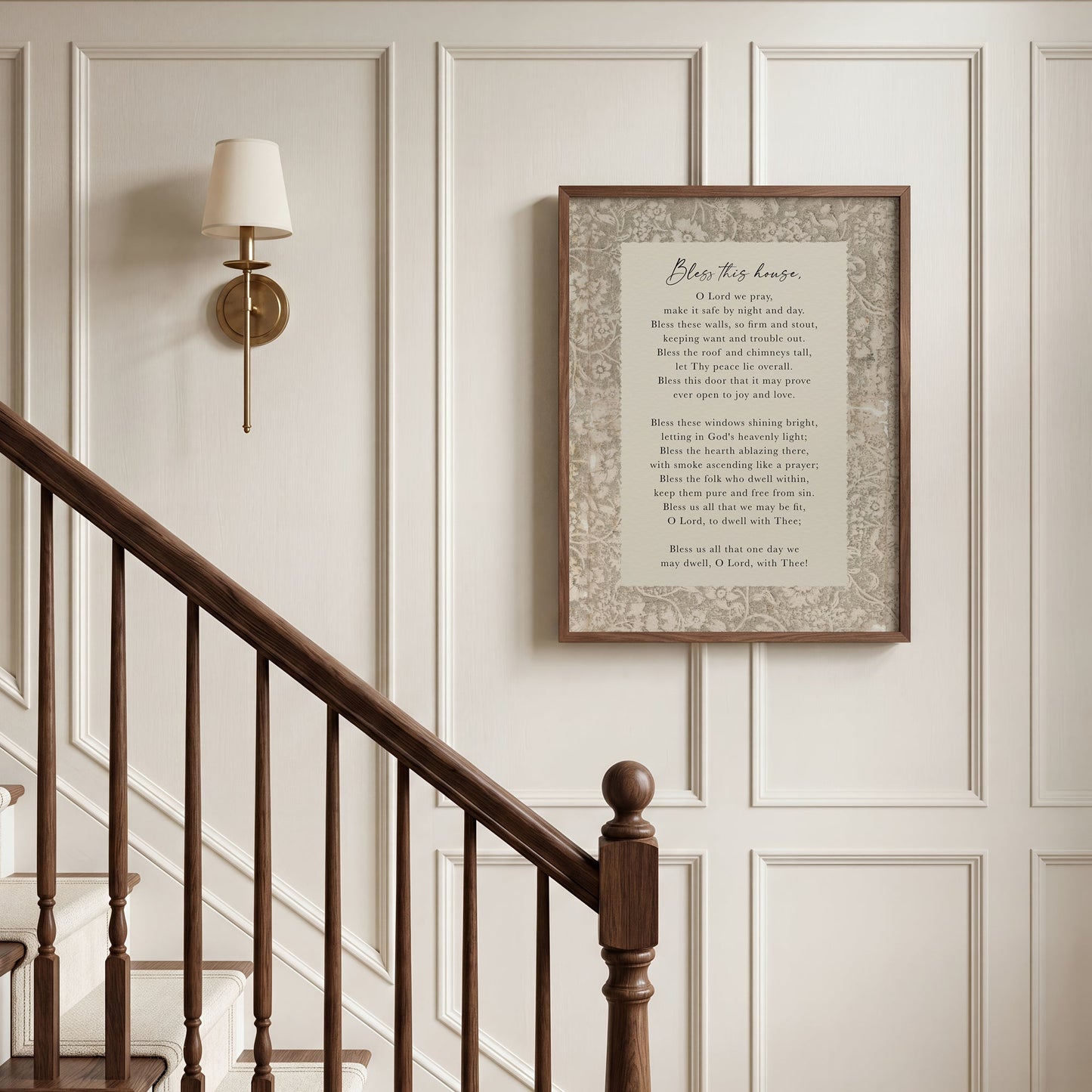 a wooden staircase with a framed text above it, and a wall lamp to the left.