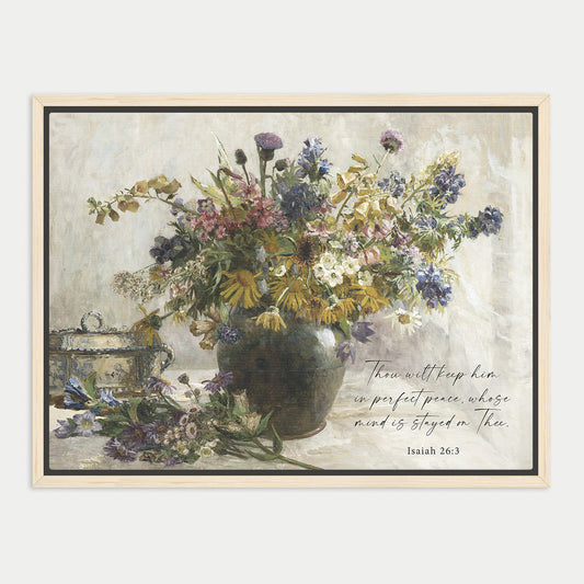 a vase filled with a variety of colorful flowers, including purple, yellow, and white blooms, placed on a table.