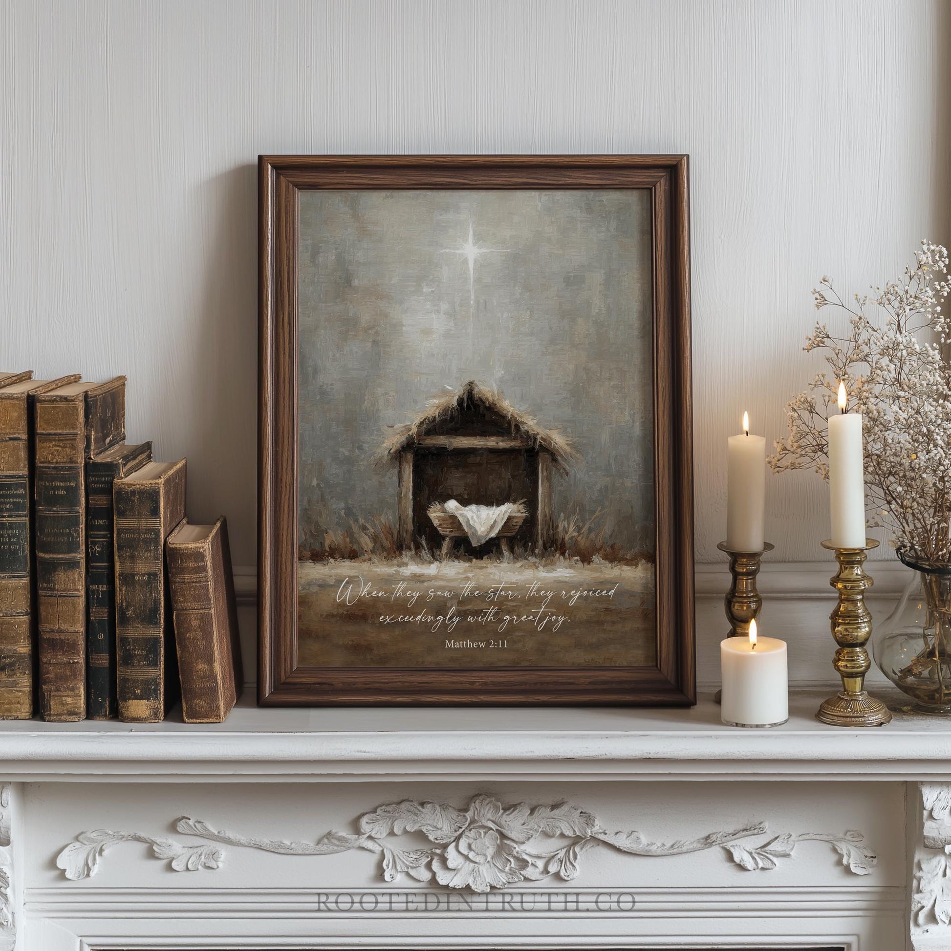a framed painting of a manger with a baby, surrounded by books, candles, and a decorative shelf.