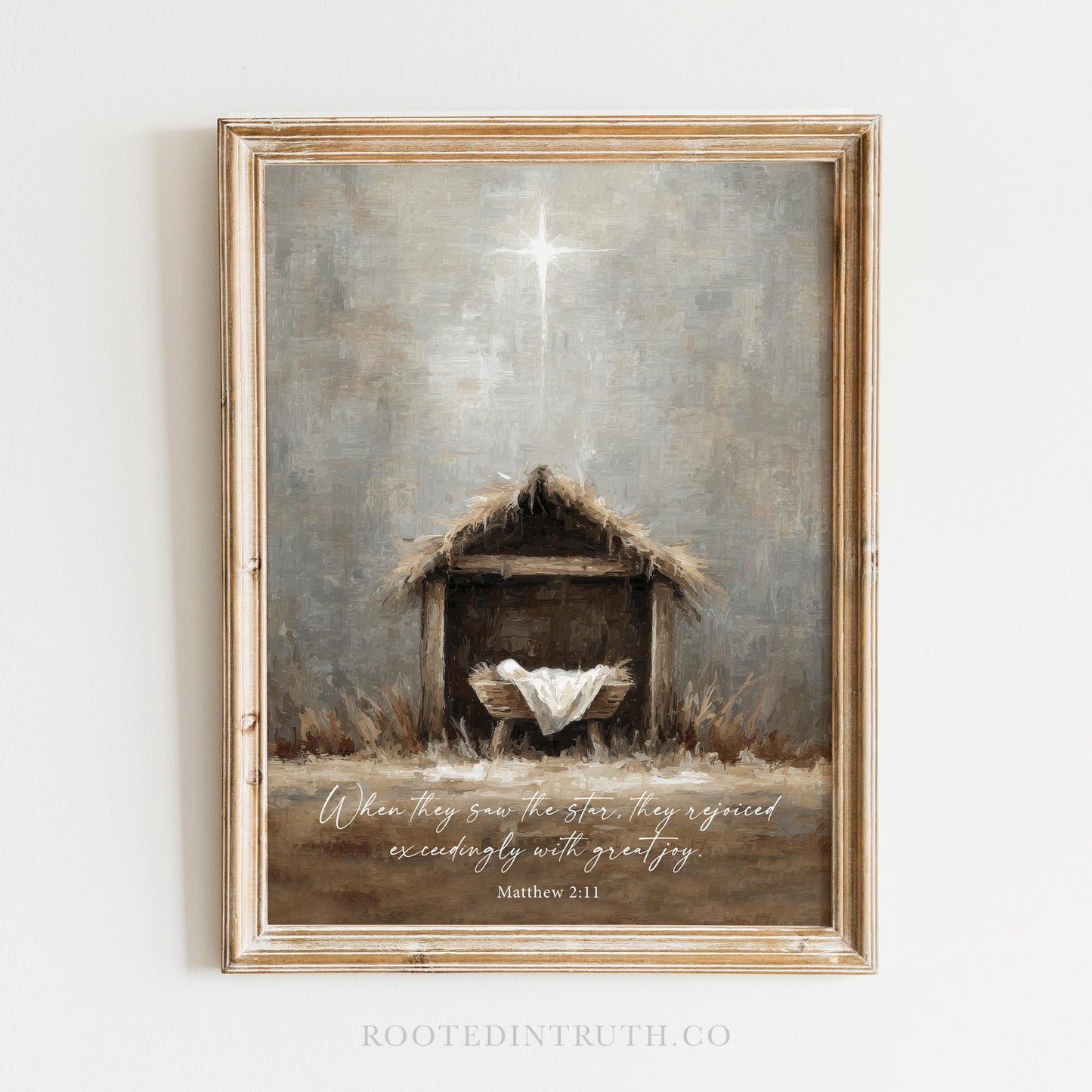 The image is a framed painting depicting a manger with a baby in it, surrounded by hay and a star, with a Bible verse from Matthew 2:11 overlaid on the scene.