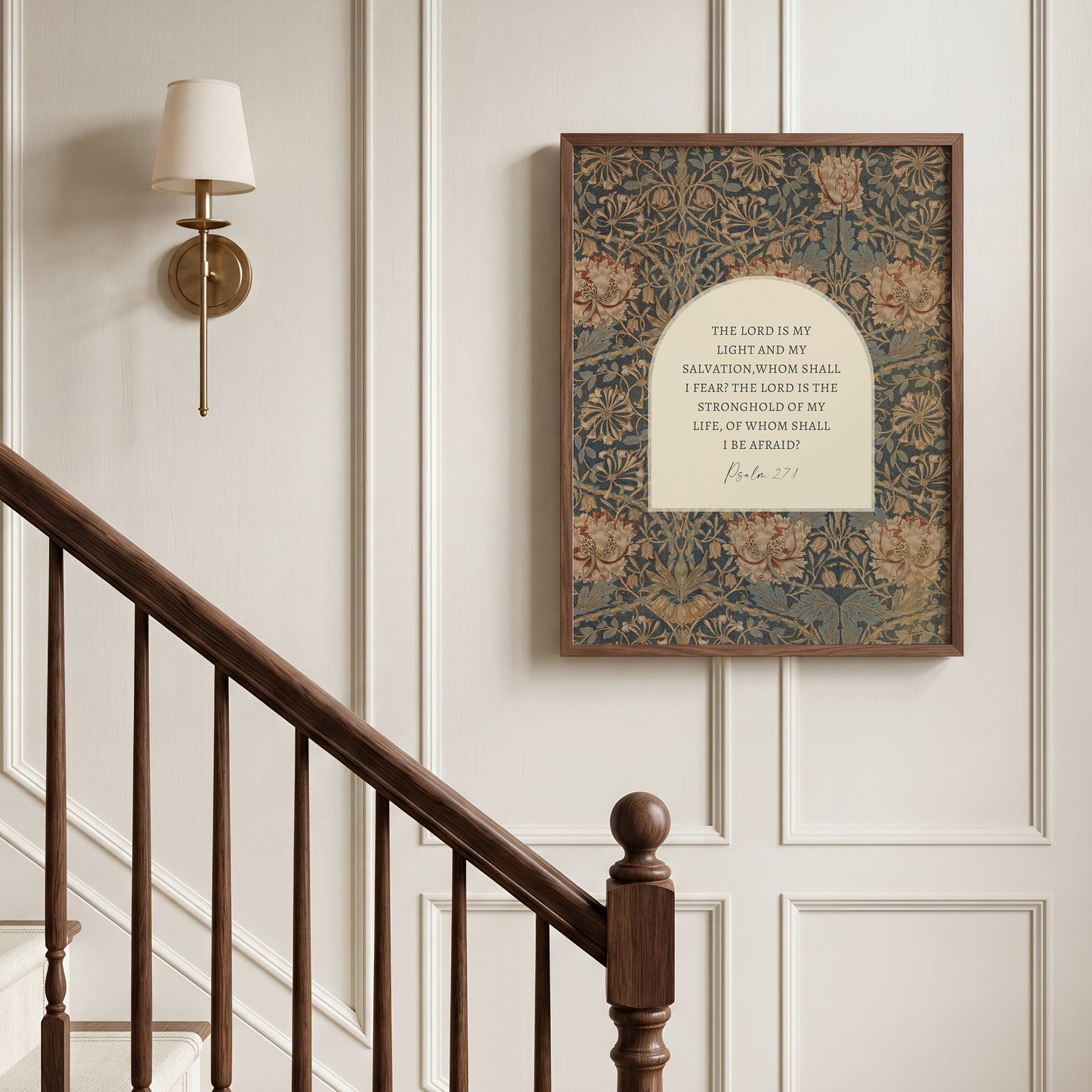 a wooden staircase with a framed print hanging on the wall above it. The print is a religious text, likely a biblical passage, and it is mounted on a wall with a white frame.
