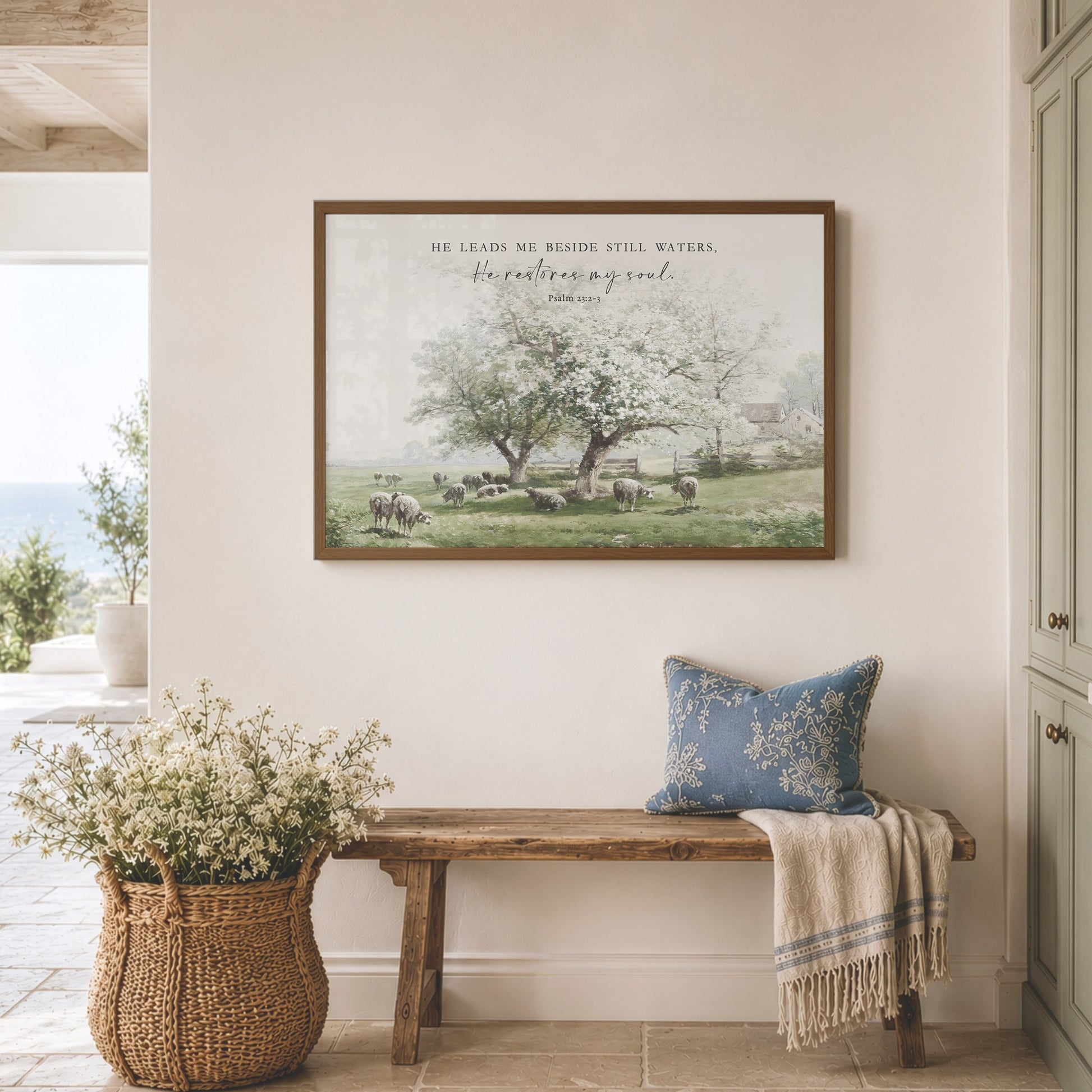 a serene indoor setting with a wooden bench, a woven basket filled with white flowers, and a framed picture of a pastoral scene hanging on the wall.