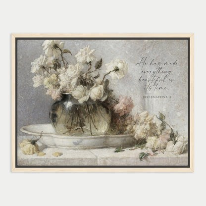 A framed painting depicting a vase filled with white roses, accompanied by a Bible verse from Ecclesiastes 9:11.