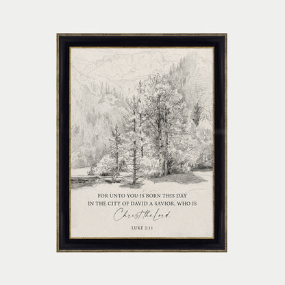 The image is a framed print featuring a black and white illustration of a forest landscape with trees and mountains in the background. The text below the image reads "FOR UNTO YOU IS BORN THIS DAY IN THE CITY OF DAVID A SAVIOR, WHO IS CHRIST THE LORD. LUCY 3:11".
