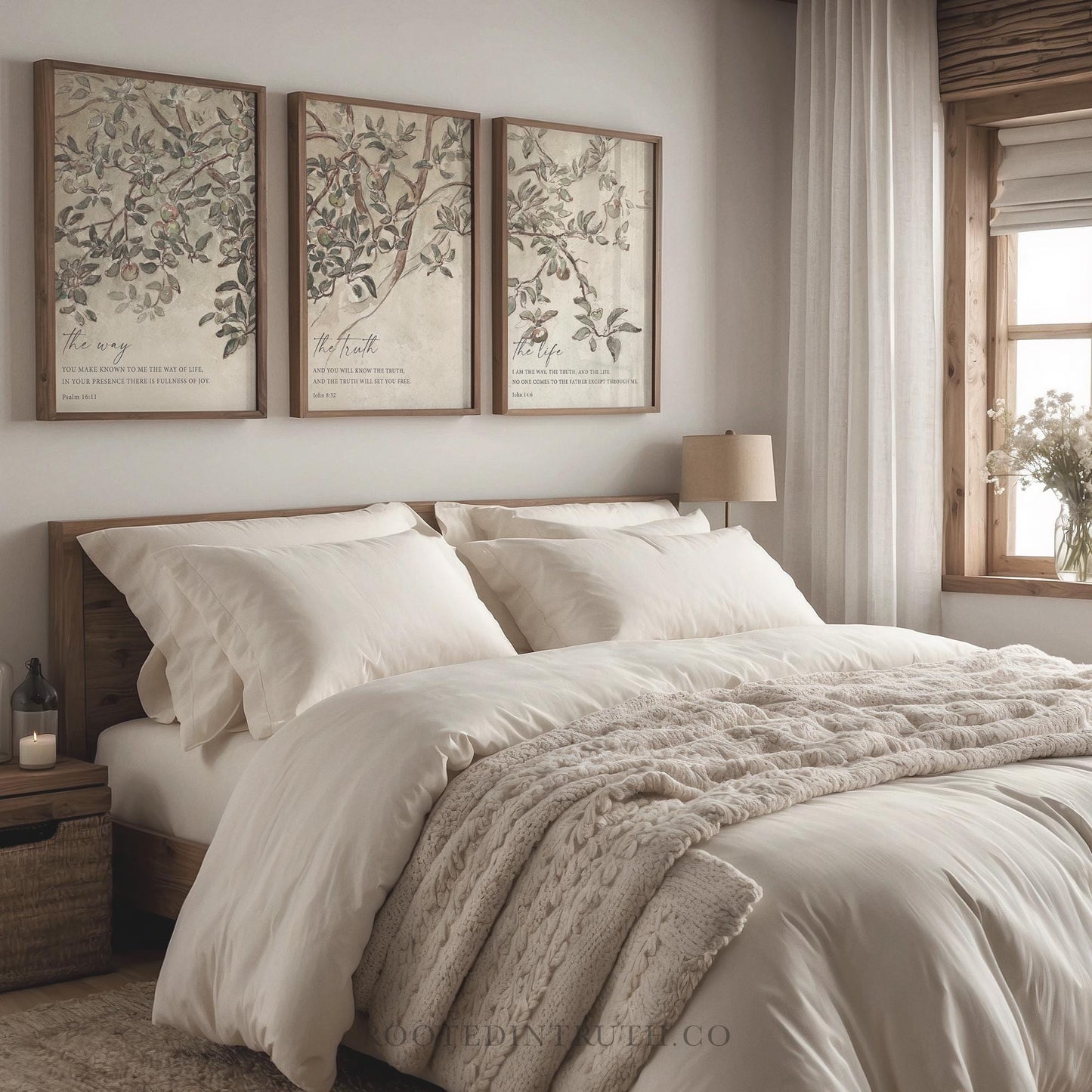 a bed with a white comforter and two pictures on the wall