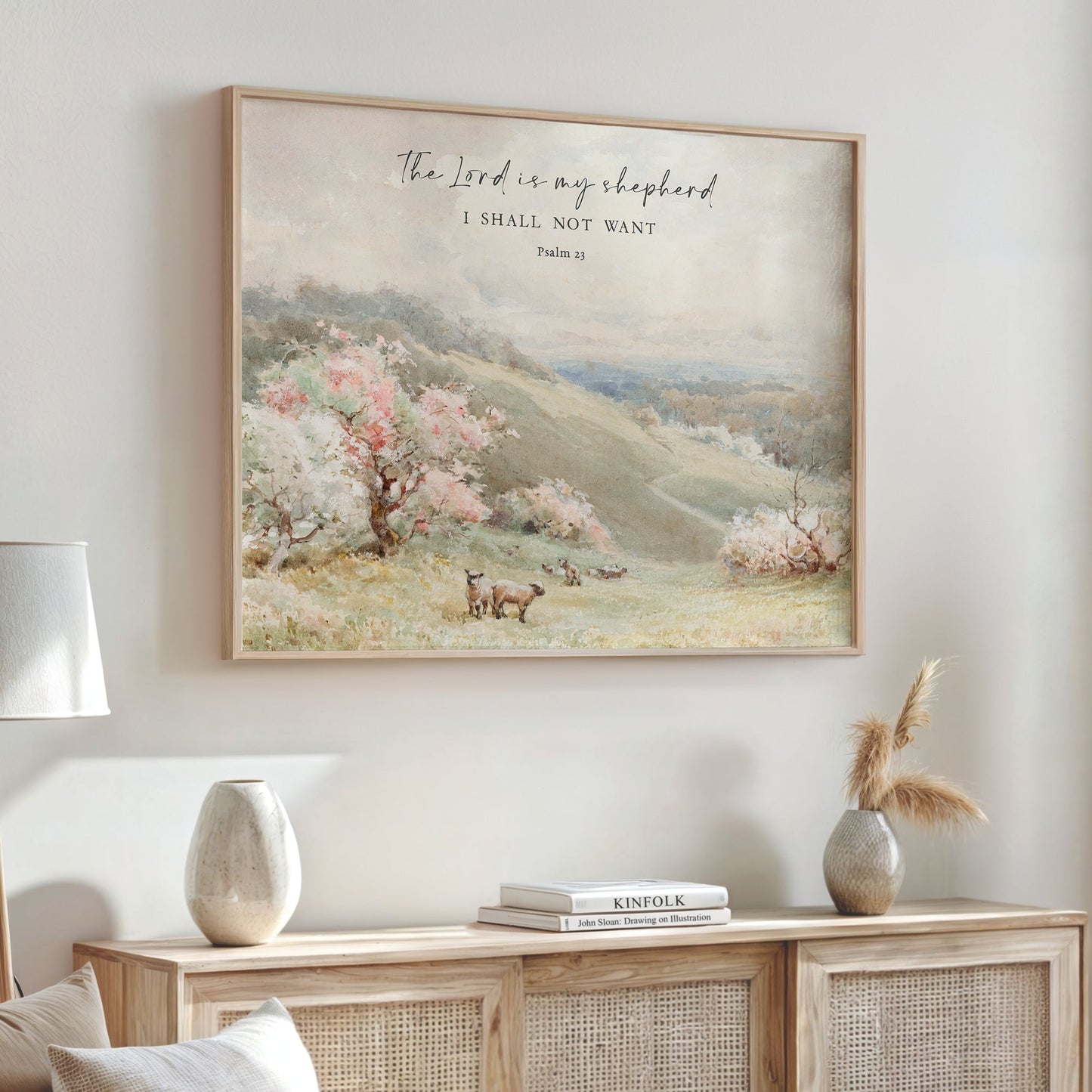 a framed painting of a pastoral landscape with a sheep grazing in the foreground, and a Bible verse from Psalm 23 is displayed above the painting.