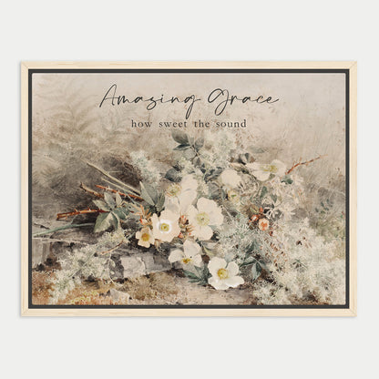 The image is a framed print featuring a floral arrangement with white flowers and greenery. The text above the print reads "Amazing Grace" and below it says "how sweet the sound".