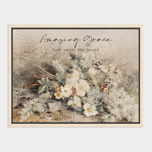 The image is a framed print featuring a floral arrangement with white flowers and greenery. The text above the print reads "Amazing Grace" and below it says "how sweet the sound".