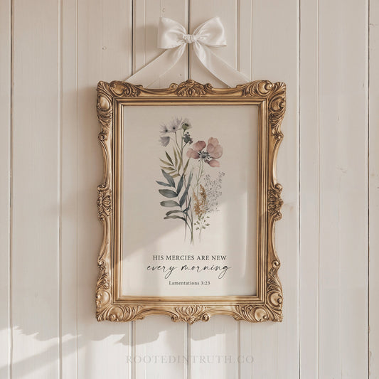 A Christian vintage style floral wall art print with a scripture bible verse hanging on a white wall in an ornate gold frame with a ribon.