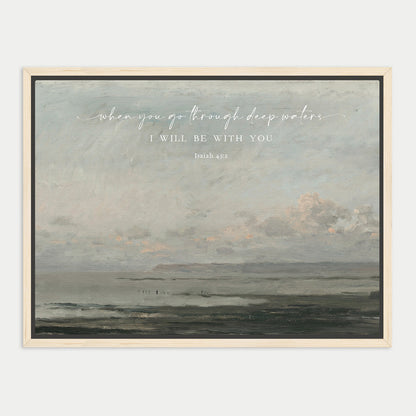 The image is a framed painting depicting a serene landscape with a body of water and a cloudy sky. The painting has a vintage or classical style, and the text overlay reads "When you go through deep waters, I will be with you. Isaiah 43".