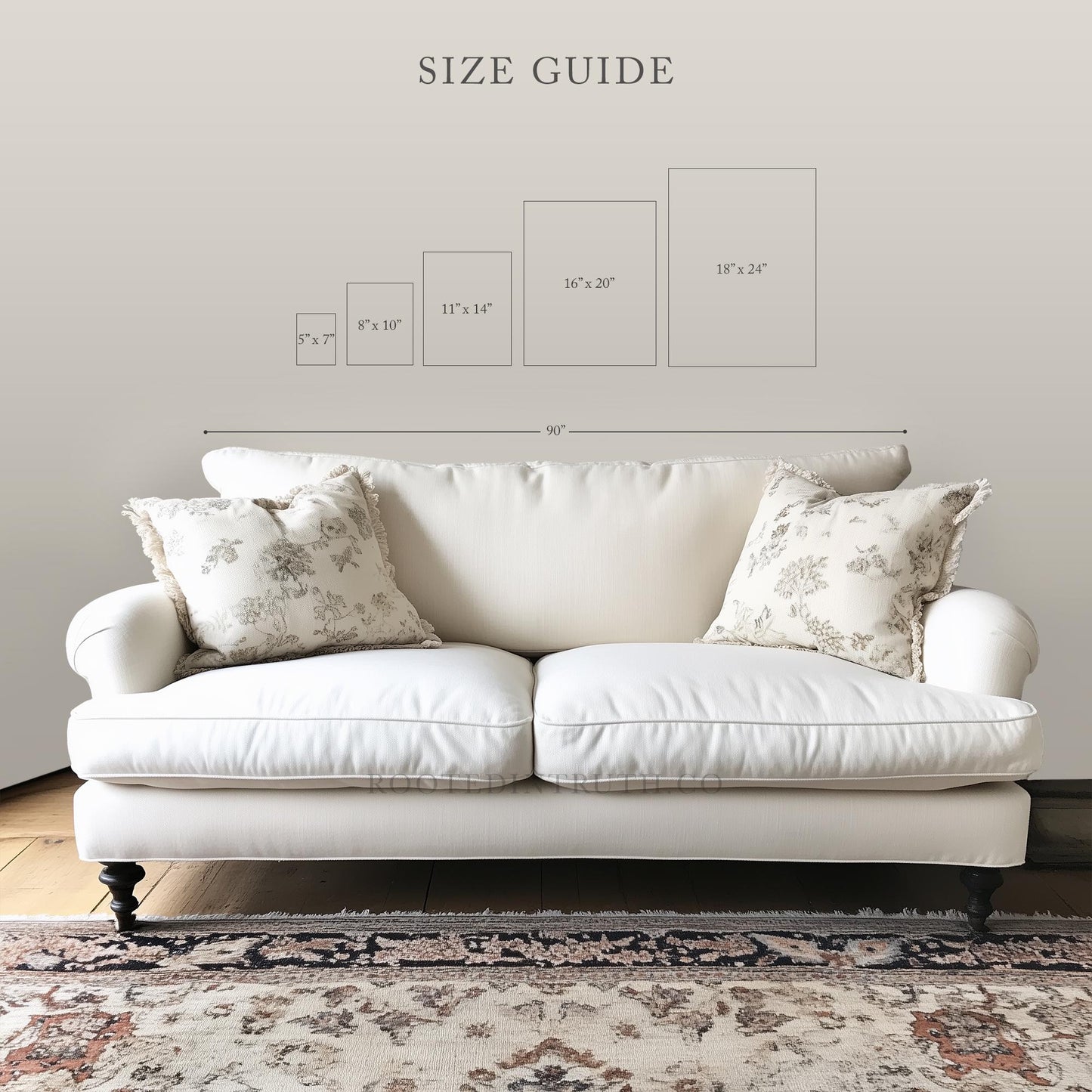 a white sofa with two pillows, placed on a rug in front of a wall with a size guide displayed above it.