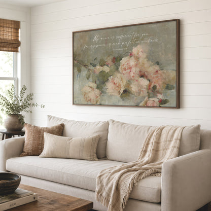 a cozy living room with a large floral painting hanging on the wall above a beige sofa. The painting depicts a bouquet of pink and white flowers, creating a warm and inviting atmosphere. The room is decorated with a wooden coffee table, a potted plant, and a vase, adding to the overall aesthetic.