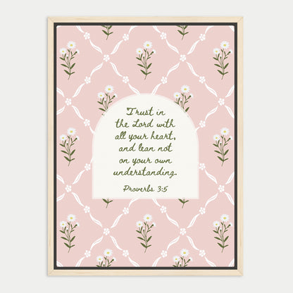 The image is a framed print featuring a repeating pattern of white flowers on a pink background. The central focus is a quote from the Bible, specifically Proverbs 3:5, which reads "Trust in the Lord with all your heart, and lean not on your own understanding."