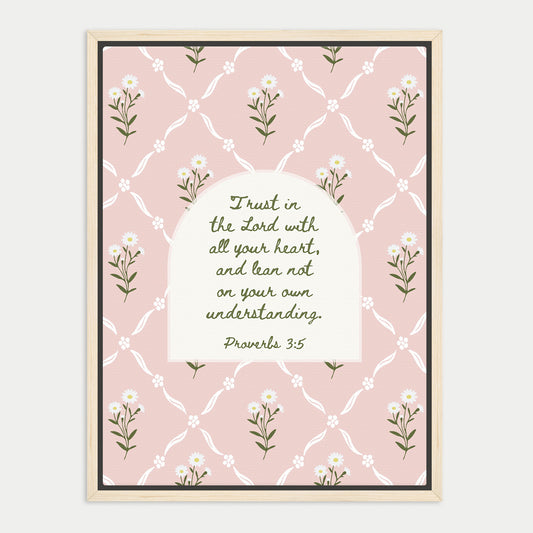 The image is a framed print featuring a repeating pattern of white flowers on a pink background. The central focus is a quote from the Bible, specifically Proverbs 3:5, which reads "Trust in the Lord with all your heart, and lean not on your own understanding."