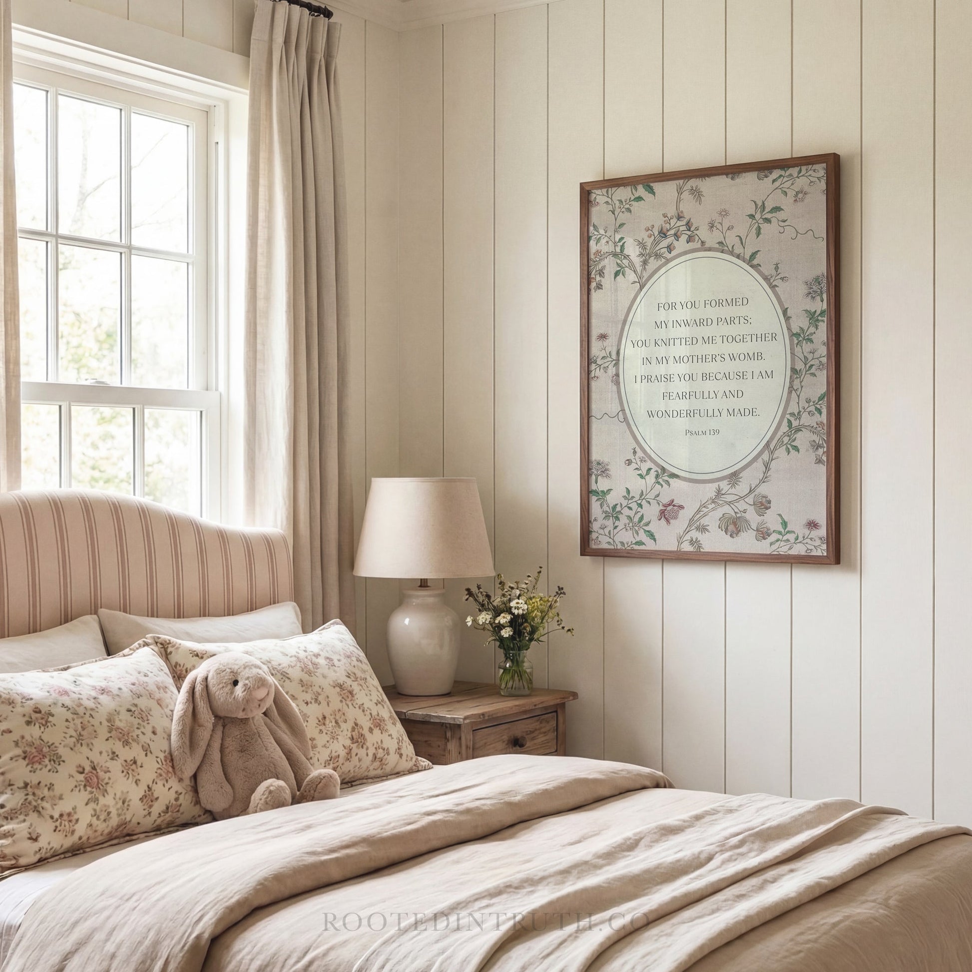 a cozy bedroom scene with a bed, a lamp, a stuffed animal, and a framed quote on the wall.