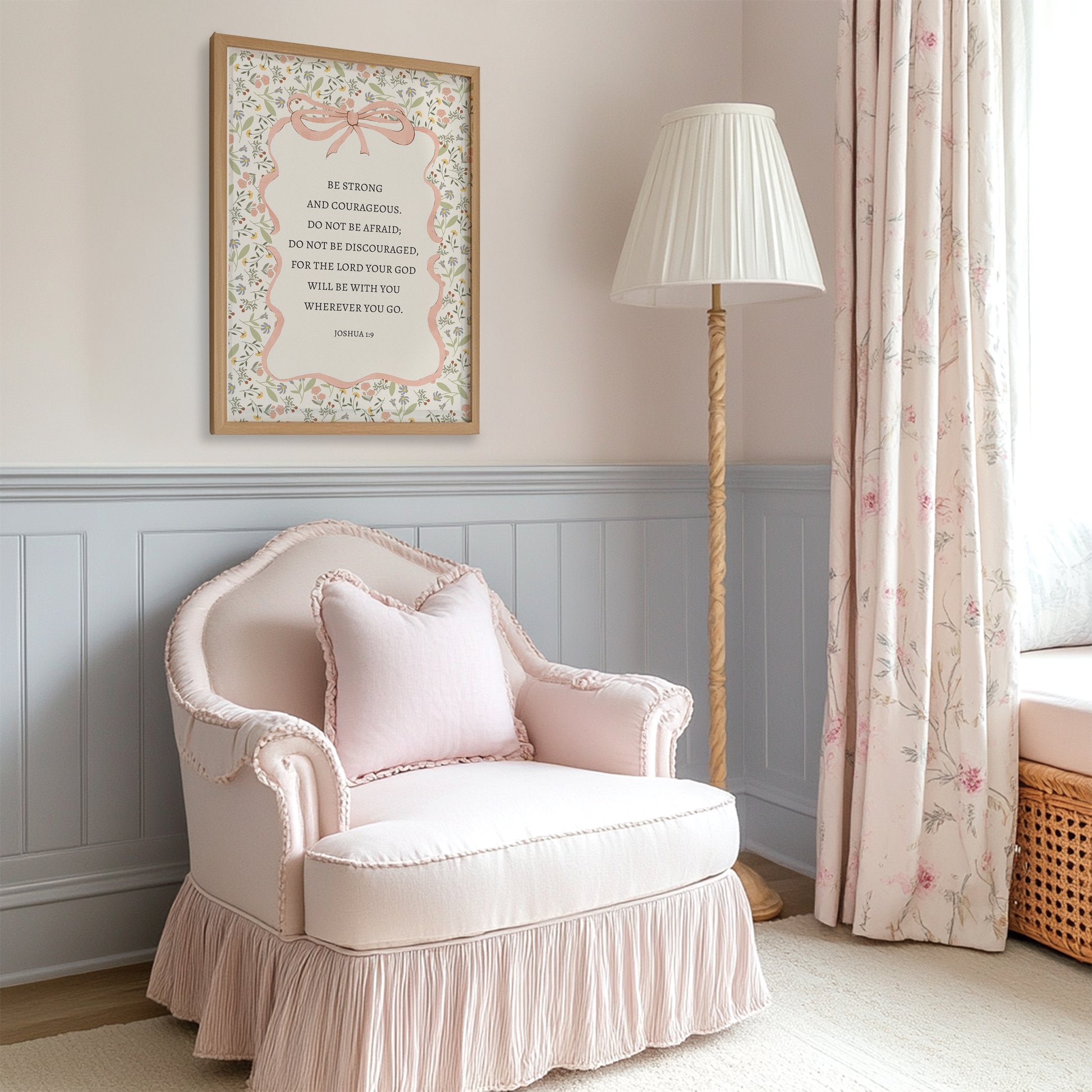 a cozy corner of a room with a pink armchair, a floor lamp, and a framed inspirational quote on the wall.