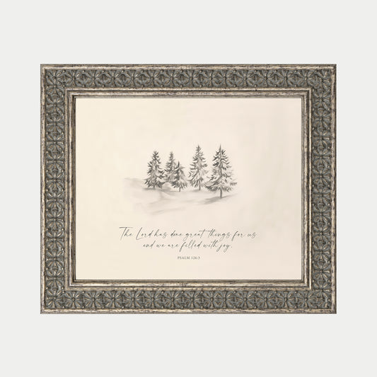 a framed illustration of a snowy landscape with a group of pine trees in the background.