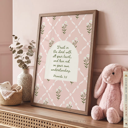 a framed print with a floral pattern and a Bible verse, accompanied by a stuffed bunny and a vase of eucalyptus leaves.