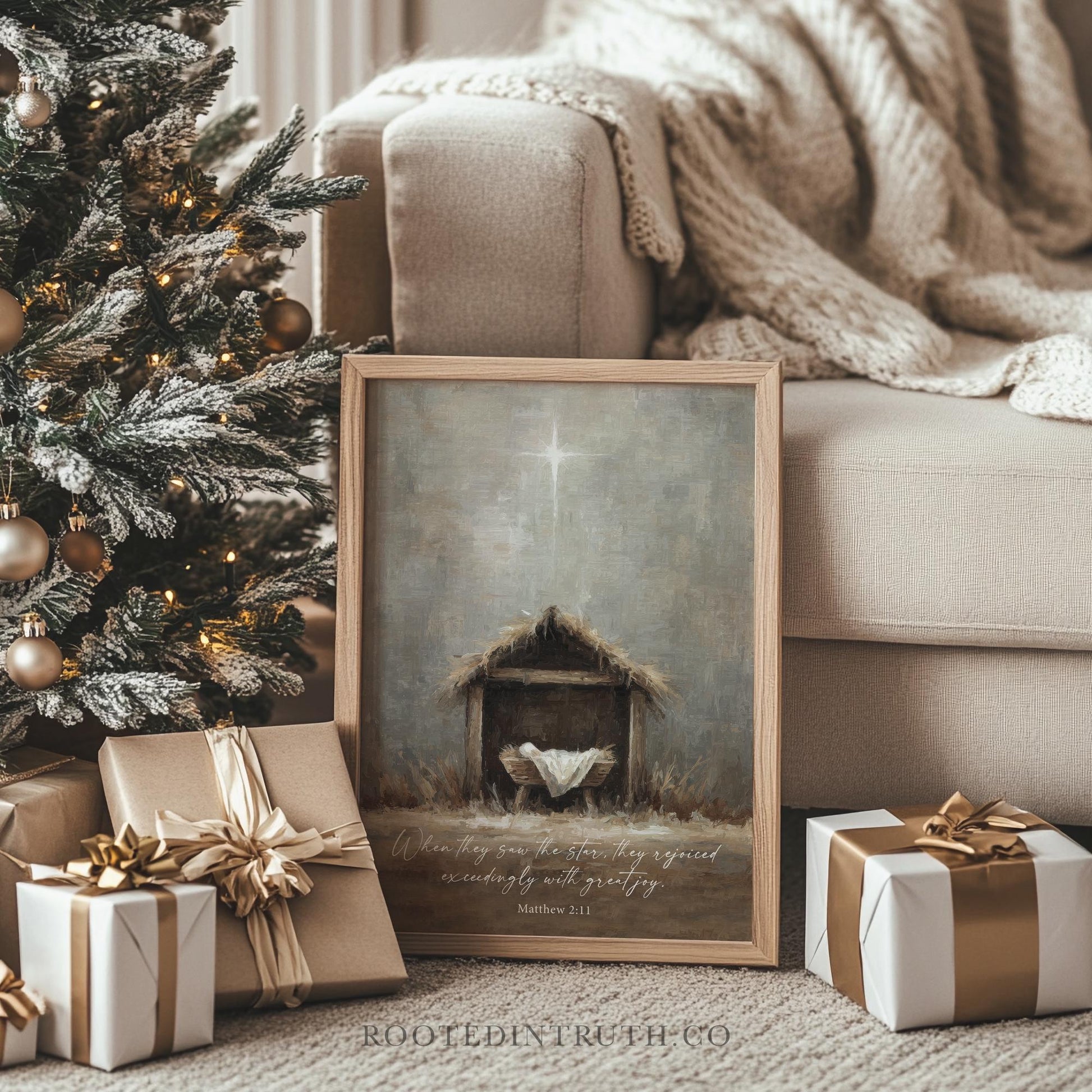 a Christmas tree with ornaments, a framed painting of a nativity scene, and wrapped gifts on a beige couch.