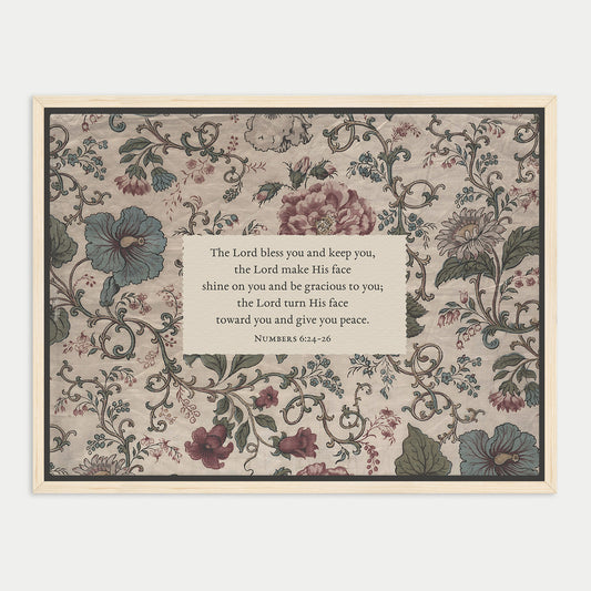 The image is a framed print featuring a floral pattern with a central text box containing a religious message.