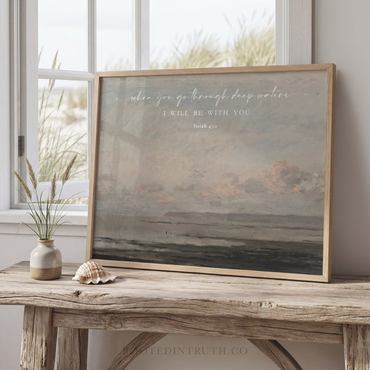 a framed painting of a serene landscape, with a vase of flowers and a seashell on a wooden table in front of it.