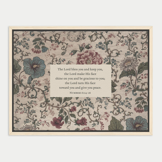 The image is a framed print featuring a floral pattern with a central text box containing a religious message.