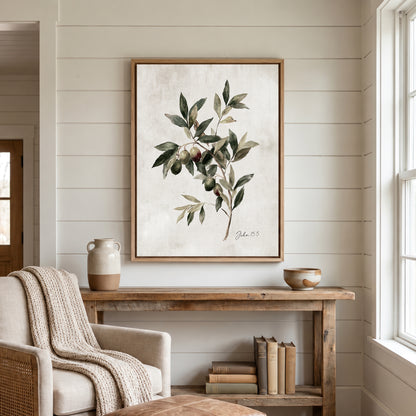 a cozy living room with a wooden console table, a beige armchair, and a framed painting of an olive tree hanging on the wall.