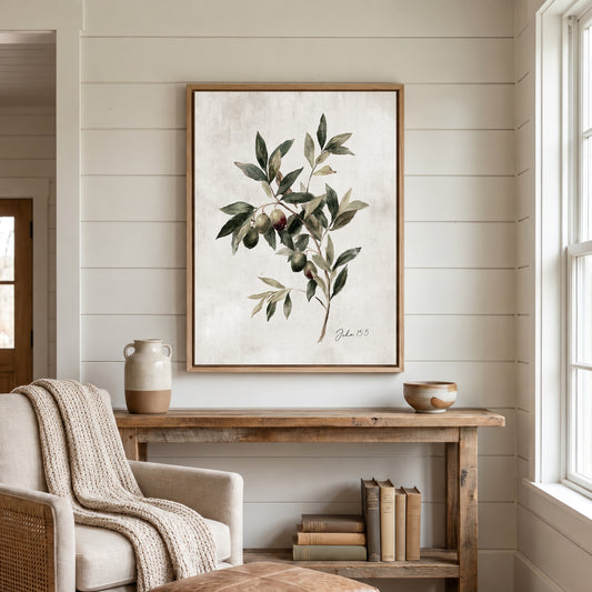 a cozy living room with a wooden console table, a beige armchair, and a framed painting of an olive tree hanging on the wall.