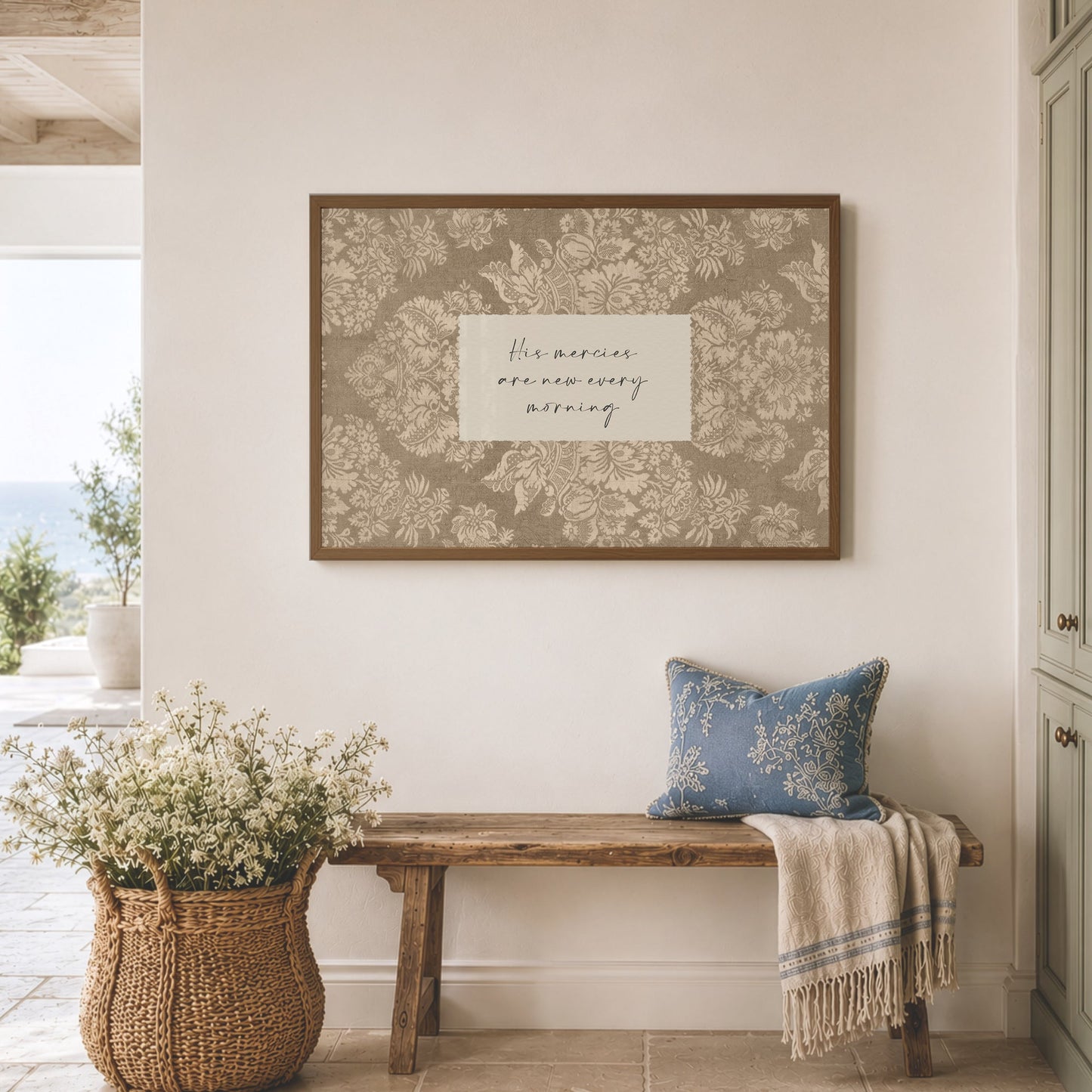 a cozy and inviting interior space with a wooden bench, a wicker basket filled with white flowers, and a framed inspirational quote on the wall.